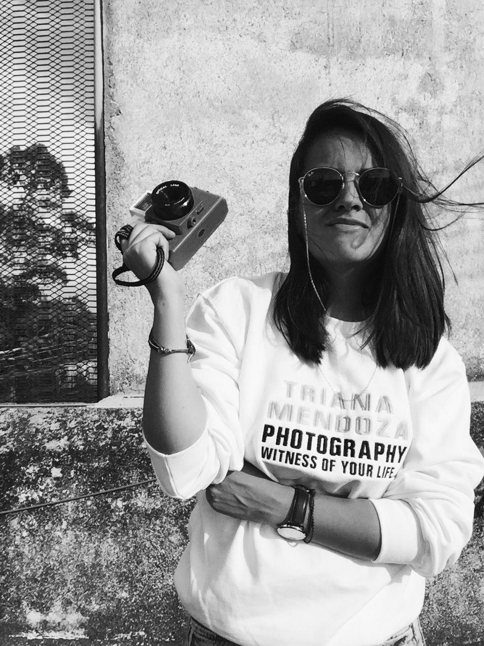 TRIANA MENDOZA Destination Wedding Photographer Female Photographer with brand sweatshirt and Holga Camera from Lomography